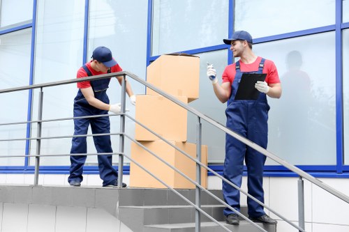 Trained removal staff demonstrating safe lifting techniques